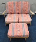 A vintage Ercol four piece suite comprising a two seater sofa, two arm chairs & a foot stool, webbin