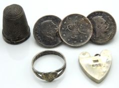 A silver coin brooch, a small silver ring, a silve
