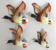 A flying duck wall plaque set, largest 200mm wide