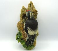 A Bossons wall plaque of woodpecker feeding chicks