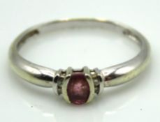 A 9ct white gold ring set with diamonds & amethyst