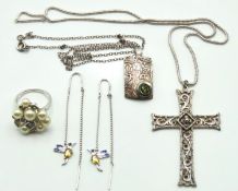 A silver cross, a silver chain with white metal av