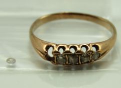 An antique rose metal ring set with five old cut d