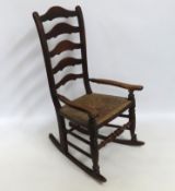 A 19thC. Lancashire oak ladderback rocking chair w