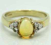 A 9ct gold ring set with yellow opal & diamond, 3.