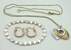 A silver gold plated chain with three heart shaped