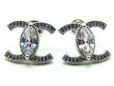 A pair of silver Chanel style earrings set with pa