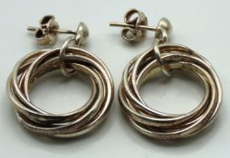 A pair of heavy gauge silver modernist intertwined
