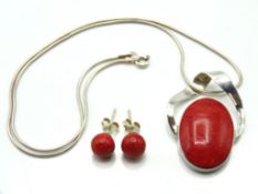 A silver mounted red coral pendant with snake chai