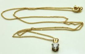 A 9ct gold chain with yellow metal set paste penda