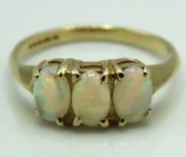 A 9ct gold ring set with three opals, 1.9g, size L