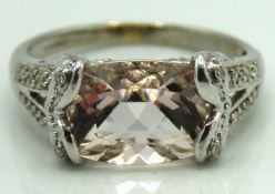 A 9ct white gold ring set with morganite & twelve