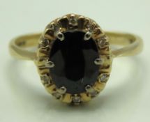 A 9ct gold ring set with sapphire & small diamonds