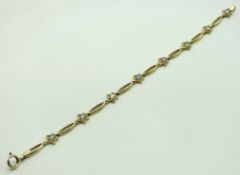 A 9ct gold bracelet set with paste stones, 185mm l