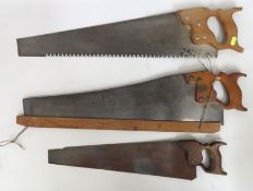 Three antique hand saws, largest 740mm overall