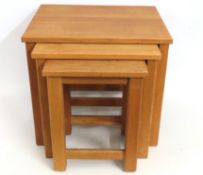 A modern oak nest of three tables, largest 510mm w