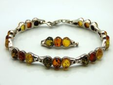 A silver & three colour amber bracelet with additi