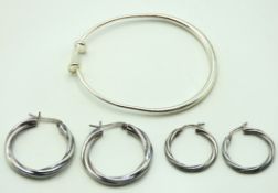 A silver bangle twinned with two pairs of silver t