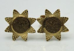 A pair of 9ct gold earrings of floral design, one