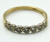 A 9ct gold half eternity ring set with heart shape