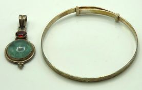 A silver bangle twinned with a silver pendant set