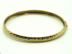 A 9ct gold bangle, internal measurement 67mm x 56m