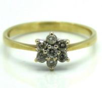 A 9ct gold daisy style ring set with approx. 0.14c