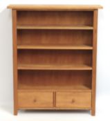 A slimline oak bookcase with two drawers under, 10