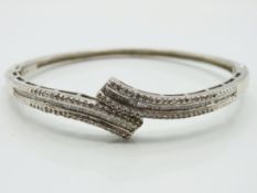 A silver bangle set with diamond, internal measure