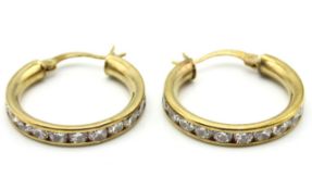 A pair of 9ct gold hoop earrings set with paste st