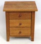 An oak three drawer bedside chest, 500mm high x 45