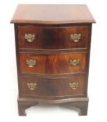 A mahogany serpentine fronted bedside chest of thr