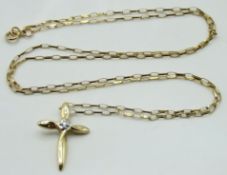 A 9ct gold chain with cross pendant set with small