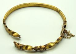 An antique yellow metal bangle, tests electronical