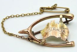 An antique 9ct gold brooch with wishbone mounting