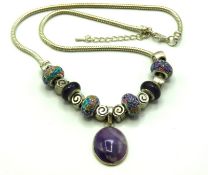 A white metal snake necklace set with glass & whit