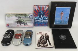 Three unboxed Bburago cars, a boxed model aircraft