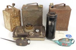 A paraffin heater, an Esso paraffin can, two oil c