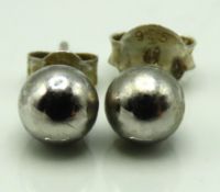 A pair of 9ct gold white studs, one has silver bac