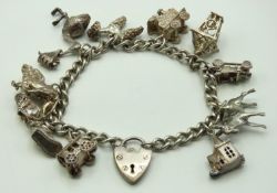 A silver charm bracelet with various charms includ