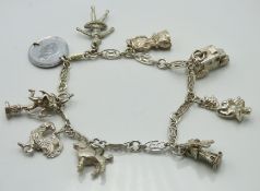 A silver charm bracelet including cockerel, baller