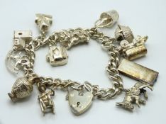 A silver charm bracelet including typewriter, cheq