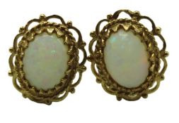 A pair of 9ct gold mounted opal earrings, 12mm x 1