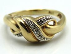 A 9ct gold ring set with five small diamonds, 3.3g