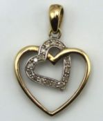 A 9ct gold heart shaped pendant set with sixteen s