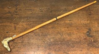 A two piece walking cane with brass horse head han
