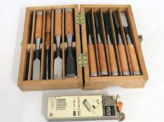 A box containing eight chisels with matching handl