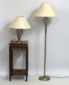 A small modern brass standard lamp twinned with si