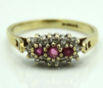 A 9ct gold ring set with diamond & pink sapphires,