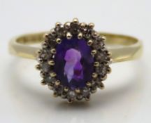 A 9ct gold ring set with amethyst & approx. 0.2ct